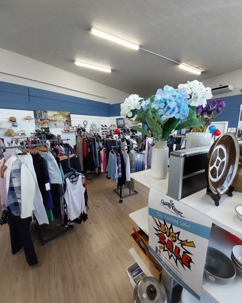 Racks of clothes and shelves of items at the Charity Corner