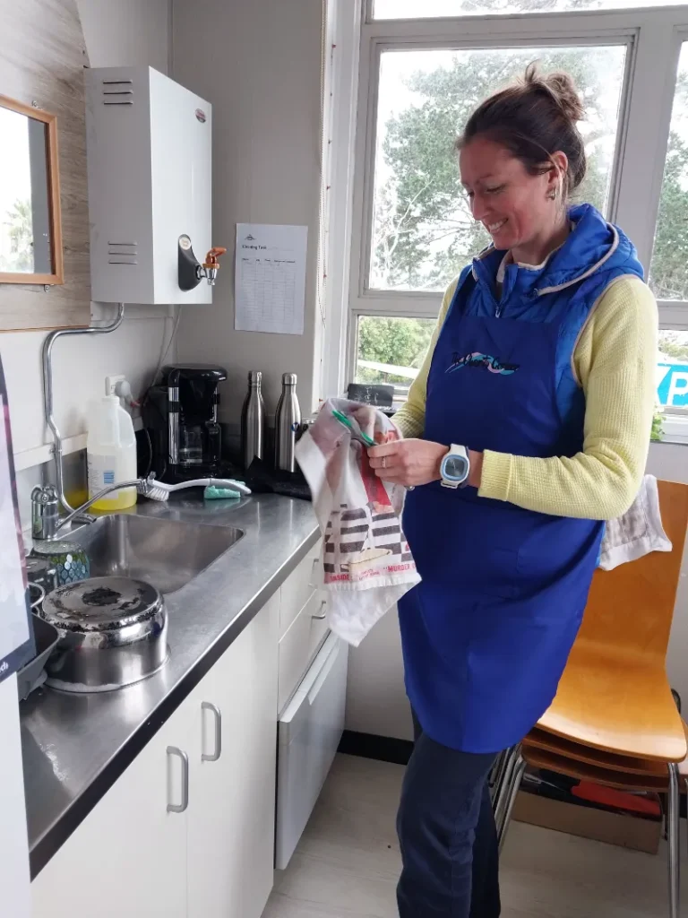 A ME Respite volunteer doing the dishes