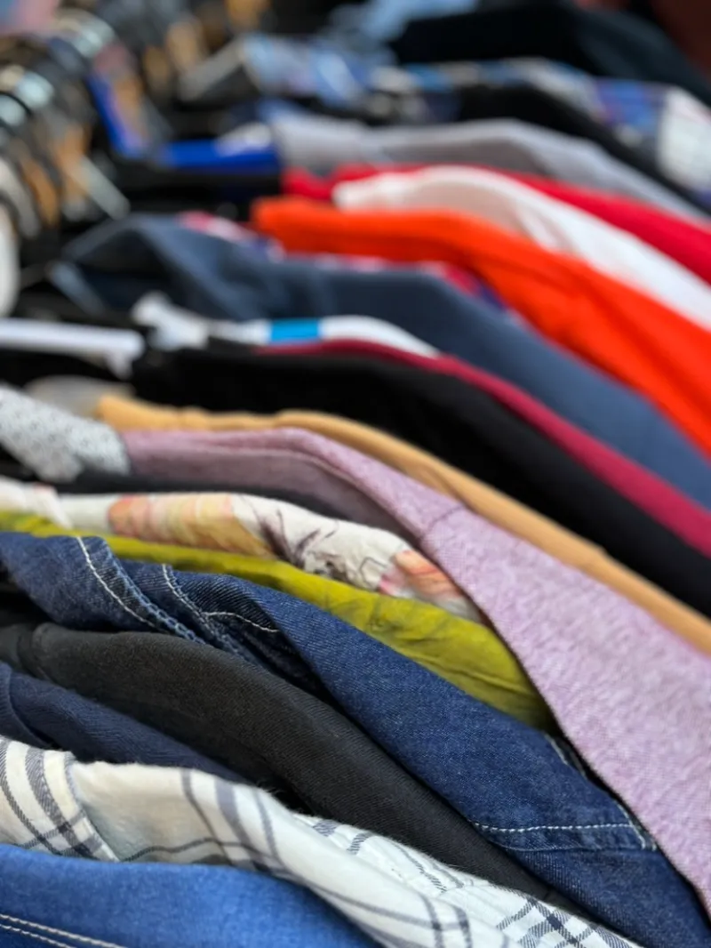 A rack of shirts and jackets at the Charity Corner